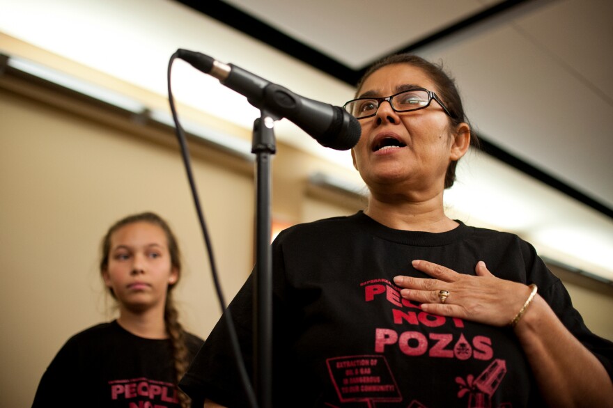 Resident Monic Uriarte of the Esperanza Community Housing Corporation speaks with her daughter, left, during a town hall meeting discussing recent findings from air monitoring and enforcement efforts related to AllenCo Energy, Inc. in the University Park. The meeting was hosted by the South Coast Air Quality Management District on Wednesday at Mount St. Mary's College.