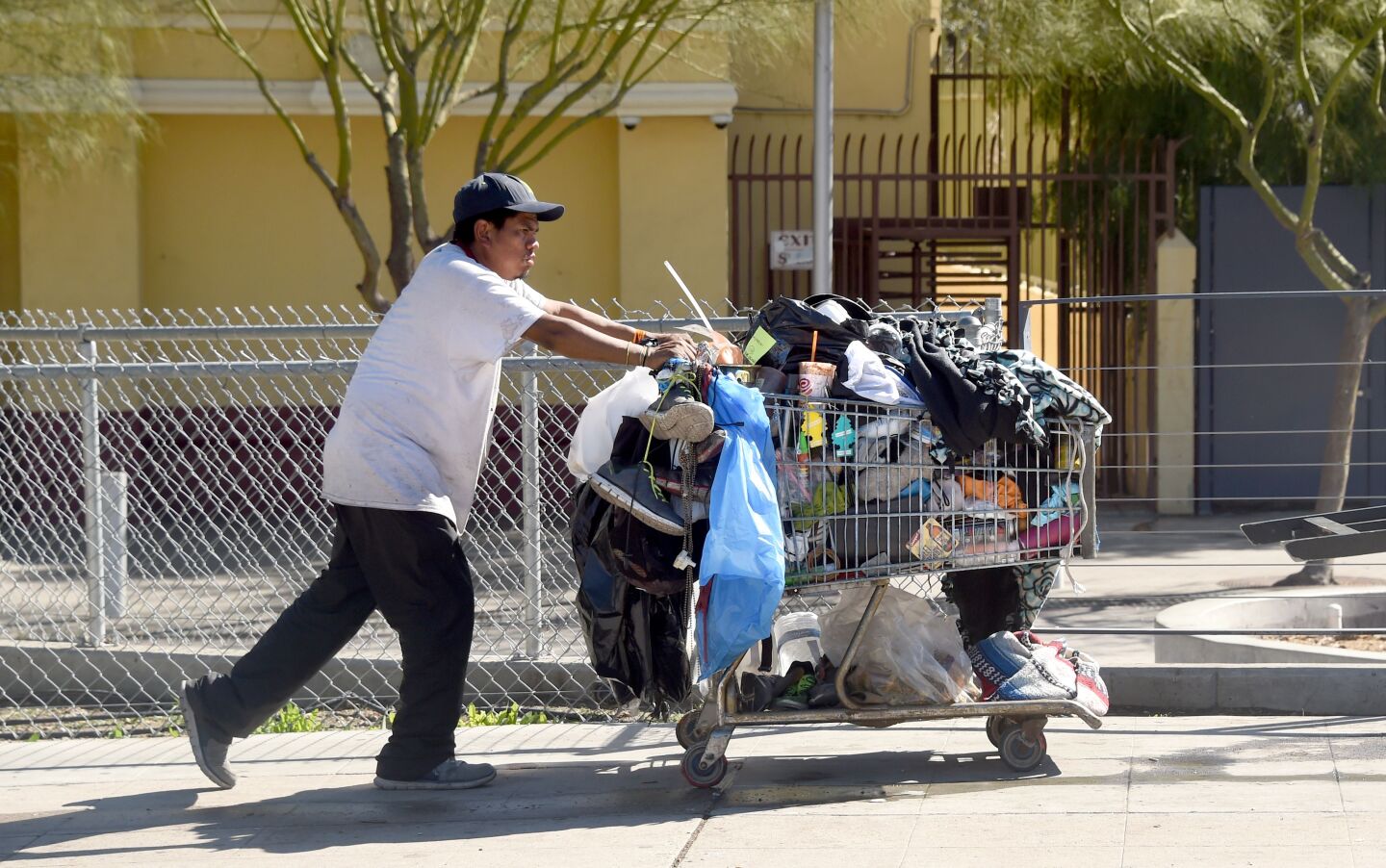 A man pushes a shopping cart full of belongings along a street in Los Angeles, California on February 9, 2016.
Los Angeles City and County officials are voting February 9 on plans aimed at ending homelessness in the community, mostly by making permanent housing available to the tens of thousands of people who are homeless.
 / AFP / Frederic J. BROWN        (Photo credit should read FREDERIC J. BROWN/AFP/Getty Images)