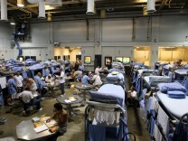 IONE, CA - AUGUST 28:  Inmates at the Mule Creek State Prison interact in a gymnasium that was modified to house prisoners August 28, 2007 in Ione, California. A panel of three federal judges is looking to put a cap on the California State Prison population after class action lawsuits were filed on behalf of inmates who complained of being forced to live in classrooms, gymnasiums and other non-traditional prison housing. California prisons house nearly 173,000 inmates with over 17,000 of them in non-traditional housing. The Mule Creek State Prison has had to modify several facilities to make room for an increasing number of inmates. (Photo by Justin Sullivan/Getty Images) 