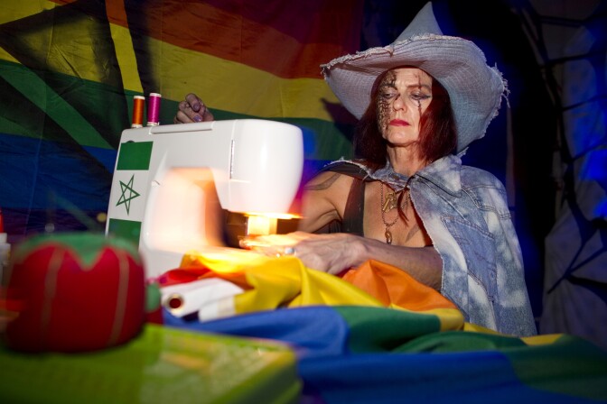 A witch sews rainbow flags with the Star of David inside a room at KillJoy's Kastle: A Lesbian Feminist Haunted House. Artists Deirdre Logue and Allyson Mitchell want the haunted house to "pervert, not convert."