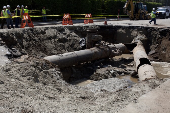 The rupture in the water main under Sunset Boulevard is visible where the two pipes converge. The other hole in the pipe, at right, is a result of the Los Angeles Department of Water & Power attempting to plug the flow of water. DWP expects to have the road patched by Saturday.