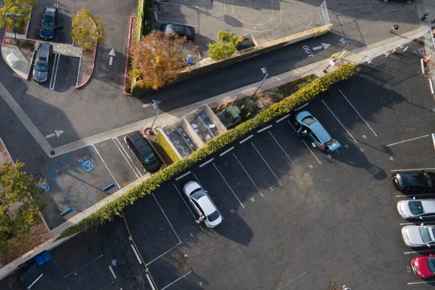 An overhead shot of cars in a parking lot.