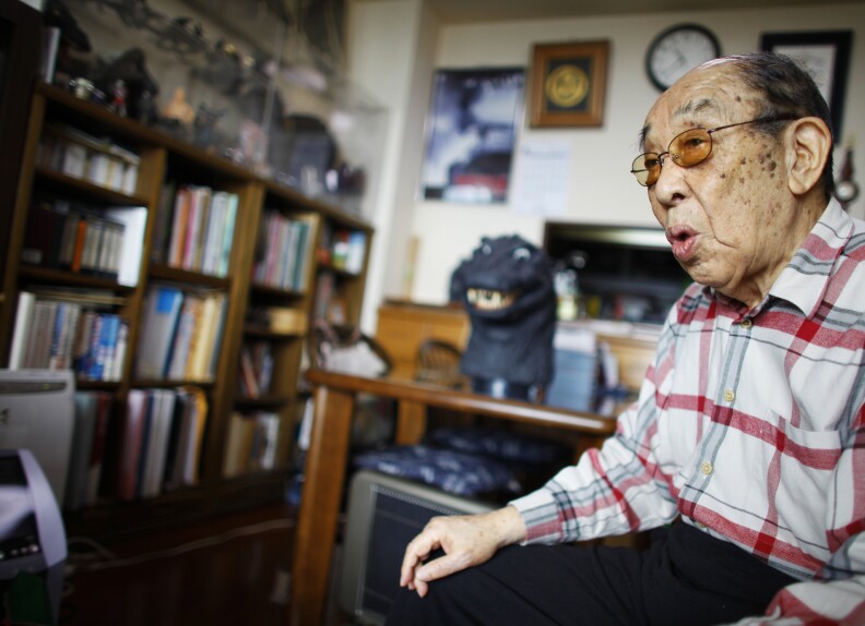 In this Monday, April 28, 2014 photo, original Godzilla suit actor Haruo Nakajima, who has played his role as the monster, speaks during an interview at his home in Sagamihara, near Tokyo. “I am the original, the real thing,” Nakajima, 85, said, stressing that later Godzilla are mere imitations. “If Godzilla can’t walk properly, it’s nothing but a freak show.” The theme of his Godzilla was grander and more complex, addressing universal human dilemma, as it spoke to a Japan that still remembered wartime suffering, he said.