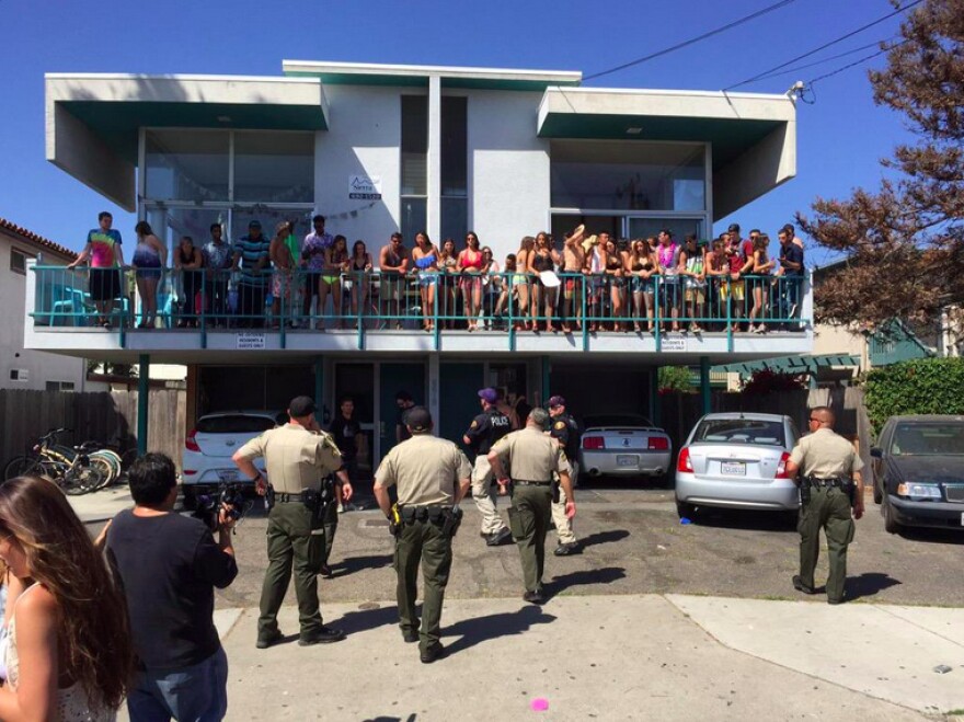 Santa Barbara County Sheriff's Office deputies approach a group of young people during the Deltopia spring break party in the Isla Vista neighborhood of Santa Barbara on Saturday, April 4, 2015.