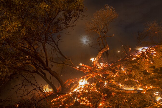 BURBANK, CA - SEPTEMBER 02: Flames spread on a moonlit night at the La Tuna Fire on September 2, 2017 near Burbank, California. Los Angeles Mayor Eric Garcetti said at a news conference that officials believe the fire, which is at 5,000 acres and growing, is the largest fire ever in L.A. People have been evacuated from hundreds of homes in Sun Valley, Burbank and Glendale. About 100 Los Angles firefighters are expected to return soon from Texas, where they've been helping survivors from Hurricane Harvey.    (Photo by David McNew/Getty Images)