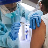 LAKEWOOD, CALIFORNIA - OCTOBER 14: A nurse administers a flu vaccination shot to a woman at a free clinic held at a local library on October 14, 2020 in Lakewood, California. Medical experts are hoping the flu shot this year will help prevent a ‘twindemic’- an epidemic of influenza paired with a second wave of COVID-19 which could lead to overwhelmed hospitals amid the coronavirus pandemic. (Photo by Mario Tama/Getty Images)