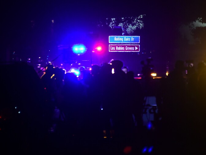 People gather as close as they can to the Borderline Bar and Grill in Thousand Oaks, California on November 8, 2018 as police vehicles closed off the area responding to a shooting.