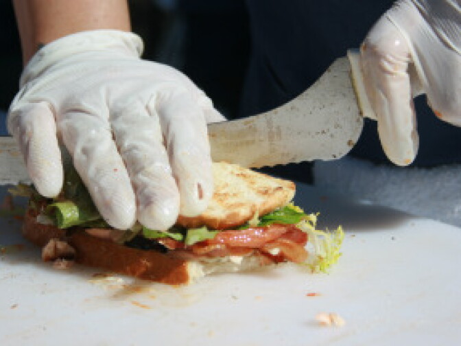 A worker prepares a sandwich at Monsieur Egg. 