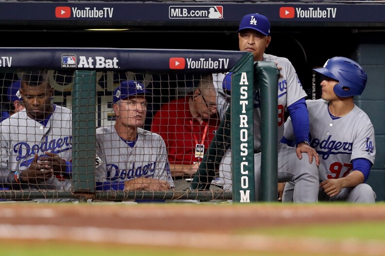 HOUSTON, TX - OCTOBER 29: Manager Dave Roberts #30 of the Los Angeles Dodgers looks on from the dugout against the Houston Astros in game five of the 2017 World Series at Minute Maid Park on October 29, 2017 in Houston, Texas.  (Photo by Christian Petersen/Getty Images)