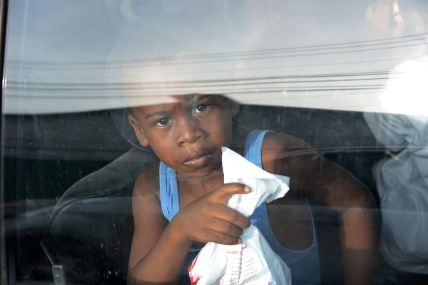 A young boy looks out of a car window upon arriving to San Pedro Sula, 240 kms north of Tegucigalpa, on July 2, 2014, after being deported from the US. Thousands of unaccompanied children, most of them from Central America, have trekked to the United States in recent months and now face deportation in what the United States has called a humanitarian crisis. 