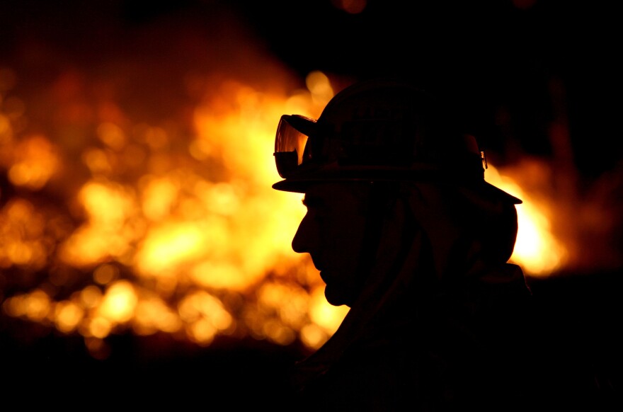File: A Los Angeles County fire fighter monitors hot spots as he fights the Station Fire August 30, 2009 in Acton, California.