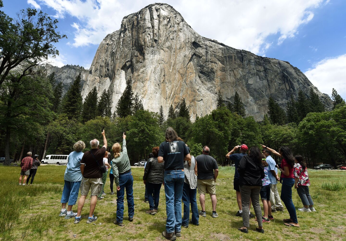 Visitors look up at the El Capitan monolith in the Yosemite National Park in California. 