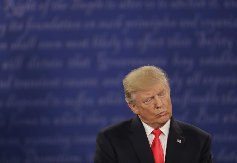 Republican presidential nominee Donald Trump listens to Democratic presidential nominee Hillary Clinton during the second presidential debate at Washington University in St. Louis, Sunday, Oct. 9, 2016. (AP Photo/Patrick Semansky)

