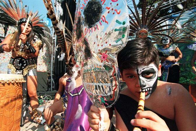 LOS ANGELES, UNITED STATES:  A boy plays the flute during a celebration of "The Day of the Dead"  01 November in East Los Angeles. The festival, both secular and religious, Catholic and pre-Columbian, is celebrated mostly by the Hispanic community of Los Angeles. Most other communities celebrate Halloween 31 October.   AFP PHOTO/Hector MATA (Photo credit should read HECTOR MATA/AFP/Getty Images)