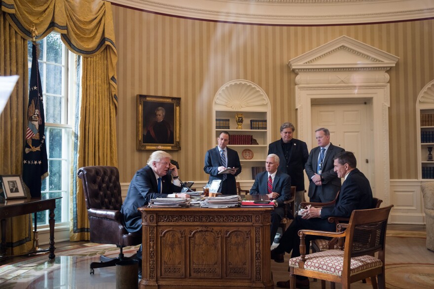 WASHINGTON, DC - JANUARY 28: President Donald Trump speaks on the phone with Russian President Vladimir Putin in the Oval Office of the White House, January 28, 2017 in Washington, DC. Also pictured, from left, White House Chief of Staff Reince Priebus, Vice President Mike Pence, White House Chief Strategist Steve Bannon, Press Secretary Sean Spicer and National Security Advisor Michael Flynn. On Saturday, President Trump is making several phone calls with world leaders from Japan, Germany, Russia, France and Australia. (Photo by Drew Angerer/Getty Images)