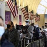 Passengers wait in line to enter a Transportation Security Administration checkpoint at Los Angeles International Airport ahead of the Thanksgiving holiday in Los Angeles, California, November 25, 2020. - US health authorities cautioned Americans on traveling for the Thanksgiving holiday, as the coronavirus spreads out of control. The recommendation was issued by the US Centers for Disease Control and Prevention, the government's health protection agency. (Photo by Patrick T. Fallon / AFP) (Photo by PATRICK T. FALLON/AFP via Getty Images)