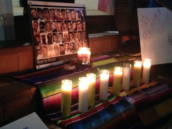 Candles next to a photo of victims of last weekend's massacre at Pulse, a gay nightclub in Orlando. The vast majority of the 49 victims killed were Latino. The vigil was organized by Somos Familia Valle, a recently formed LGBT Latino advocacy group in the Valley.