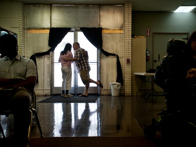 Michelle Marks chats with producer and co-director Steve Niel at the front entrance to Performing Arts Studio West in Inglewood. More than 100 performers and behind-the-scenes staff are involved in putting on their 15th anniversary performance.