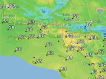 A map of the greater Los Angeles area, Orange County and Inland Empire. It is colored in various shades of yellow, green and blue to indicate different temperatures. There are numbers superimposed on the map indicating daytime high temperatures.