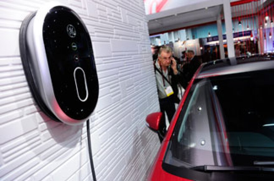 An attendee looks GE's new Residential WattStation plugged into a Chevrolet Volt electric car at the 2011 International Consumer Electronics Show January 8, 2011 in Las Vegas.