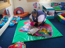 Rosa Sanchez lays a child down to rest at Jardín de Niños, which is part of the California Children's Academy that helps families become financially independent by providing affordable child care to low income families.