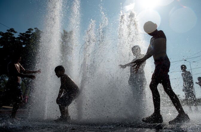 Children play in a fountain during a hot summer day in Santiago's main square, on February 2, 2016. AFP PHOTO/ MARTIN BERNETTI / AFP / MARTIN BERNETTI        (Photo credit should read MARTIN BERNETTI/AFP/Getty Images)