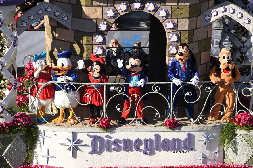 Disney characters wave from Disneyland Resort's Diamond Celebration float celebrating the park's 60th anniversary, in the 127th Rose Parade in Pasadena on Jan. 1, 2016.