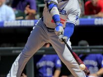Los Angeles Dodgers' Carl Crawford (25) hits a double off of Colorado Rockies starting pitcher Jhoulys Chacin (45) during the third inning of the MLB National League baseball game Saturday June 1, 2013 in Denver. Crawford hurt his leg on the play and had to leave the game. 
