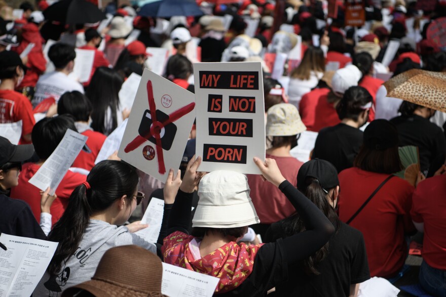 Female protesters call for South Korea's government to crack down on widespread spycam porn crimes during a rally in Seoul on July 7, 2018. - So-called "molka" (spycam videos) have become increasingly common in the high-tech South where men caught secretly filming women -- in schools, workplaces, changing rooms and even public toilets -- make headlines on a daily basis. (Photo by STR / AFP)        (Photo credit should read STR/AFP/Getty Images)