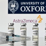 An illustration picture shows vials with Covid-19 Vaccine stickers attached and syringes, with the logo of the University of Oxford and its partner British pharmaceutical company AstraZeneca, on November 17, 2020. (Photo by JUSTIN TALLIS / AFP) (Photo by JUSTIN TALLIS/AFP via Getty Images)