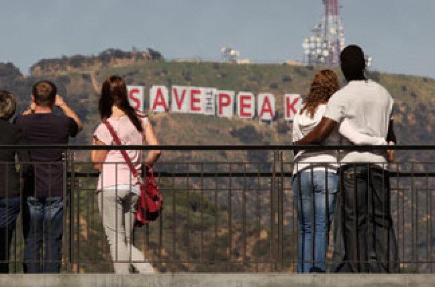 Visitors to the Hollywood and Highland complex view the iconic 450-foot-long Hollywood sign after activists covered it with banners during an effort to prevent the building of houses there on February 13, 2010.