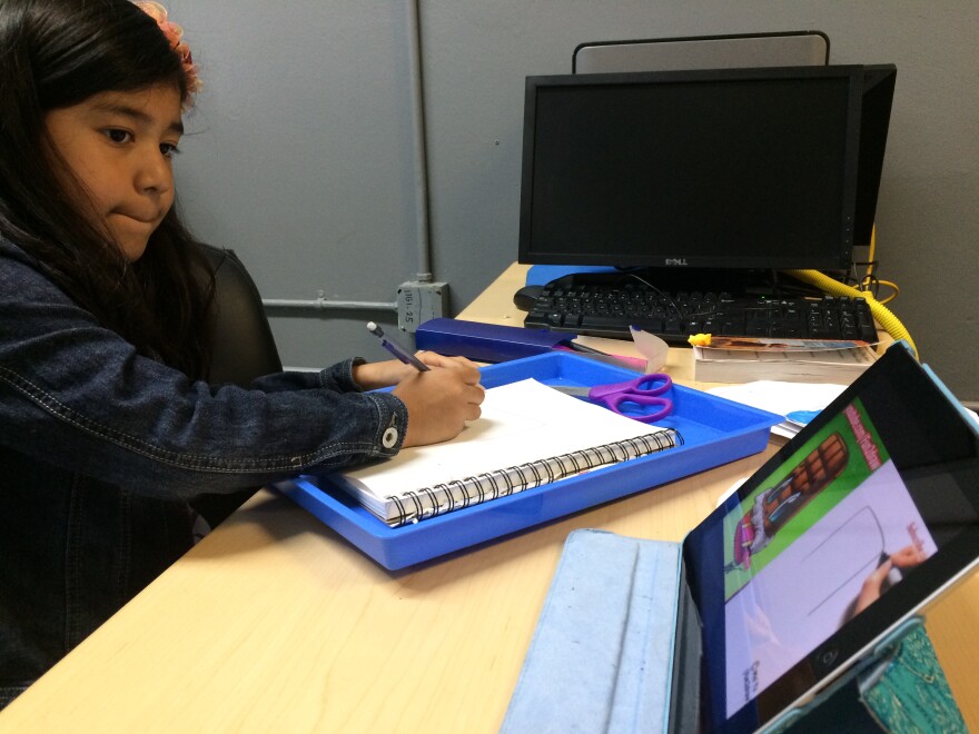 Cristina Zaldivar, 9, uses an iPad to learn to draw at the Bell Technology Center during a computer class.