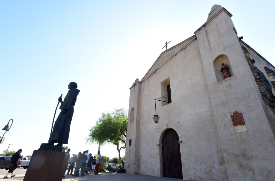 Ernesto Salas, chief of a group of Kizh Nation Indians leads a ceremony honouring their ancestors beside the statue of Father Junipero Serra which stands in front of the San Gabriel Mission in San Gabriel, California on September 23, 2015 moments after visiting Pope Francis made the controversial Spanish Missionary a Saint while celebrating the first canonization on U.S. soil during a Mass at the Basilica of the National Shrine of the Immaculate Conception in Washington DC.  Some fifty different tribes in California have condemned the sainthood conferred on Serra, according to Deborah Miranda, author of "Bad Indians: A Tribal Memoir," a book about her ancestors' experiences in the Spanish missions and member of the Ohlone Costanoan Esselen Nation of California. AFP PHOTO / FREDERIC J. BROWN        (Photo credit should read FREDERIC J. BROWN/AFP/Getty Images)