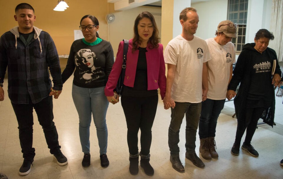 Hyepin Im joins other volunteers in a time of prayer before the 2018 Koreatown Homeless Count on Jan. 25, 2018. The volunteers had a joint time of prayer in English, than individual prayer time in several languages, including Spanish and Korean.