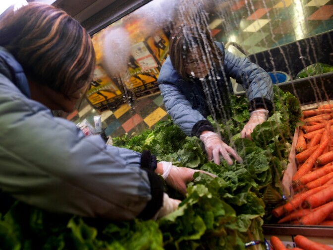 The Camp Pendleton commissary remains open on Tuesday, in order to sell off perishable goods. But base officials expect it to close by Wednesday. Store worker Lolita Garcia waters vegetables every two hours while the sprinklers are repaired on Jan. 24, 2013. The Commissary does not make any profits, they charge a five percent overhead on each product which covers employees' salaries.