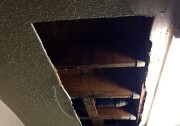 The county has struggled to maintain public housing units scattered across southern L.A. Sherrie King says this hole's been in her ceiling for months.