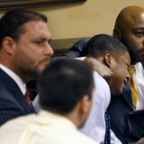 Defense attorney Walter Madison, right, holds his client, 16-year-old Ma'Lik Richmond, second from right, while defense attorney Adam Nemann, left, sits with his client Trent Mays, foreground, 17, as Judge Thomas Lipps pronounces them both delinquent on rape and other charges after their trial in juvenile court in Steubenville, Ohio, Sunday, March 17, 2013. Mays and Richmond were accused of raping a 16-year-old West Virginia girl in August 2012. (AP Photo/Keith Srakocic, Pool)