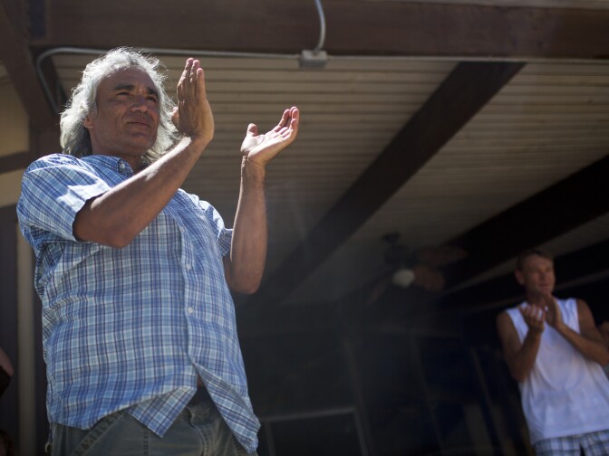 Ambrose Smith of Salton City applauds as Randy Brown arrives for lunch and a swim at Vista Del Mar Clubhouse during his six-day walk around the Salton Sea on Friday, June 12, 2015. Smith, who has lived near the Salton Sea for nine years, has been following Brown's journey all week.