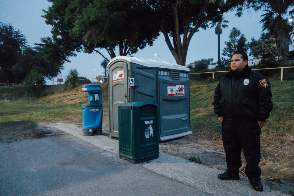 Bill Garcia with Premiere Security Group stands watch at the lot designated for safe parking at the West L.A. VA campus. 