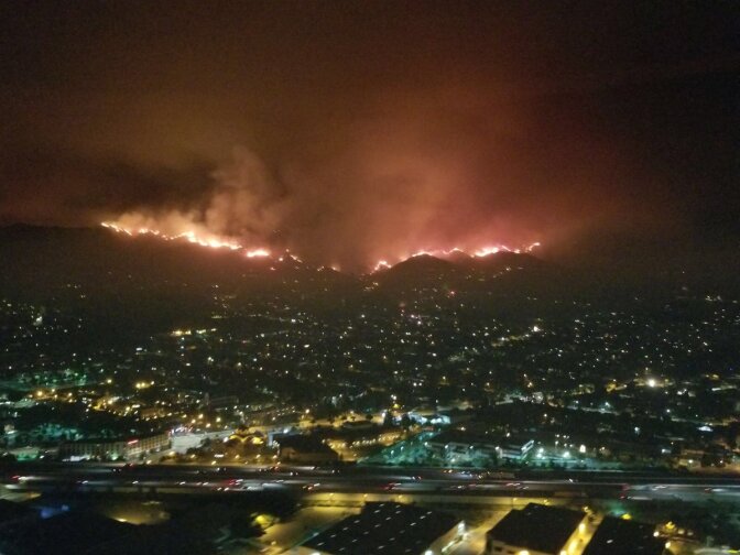 The La Tuna Fire burns in the hills above Burbank, early September 2, 2017.
