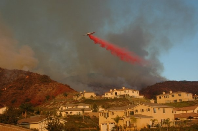 Firefighters drop retardant during the Santiago Fire in Orange County in 2007.  The wind-driven wildfire destroyed a dozen homes.