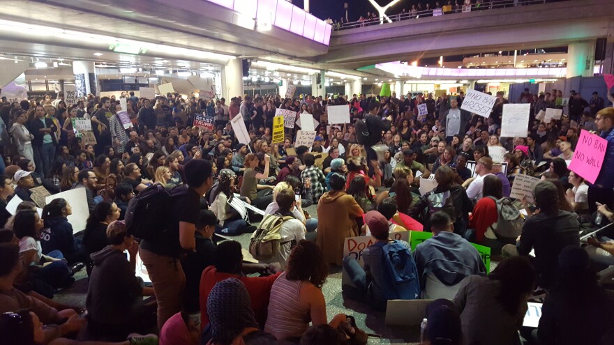 As the evening wore on, protesters convened outside the Tom Bradley International terminal at Los Angeles International Airport on Sunday, Jan. 29, 2017. The protesters were calling for the release of immigrants detained under President Donald Trump's executive order effectively banning travel from seven majority Muslim nations.