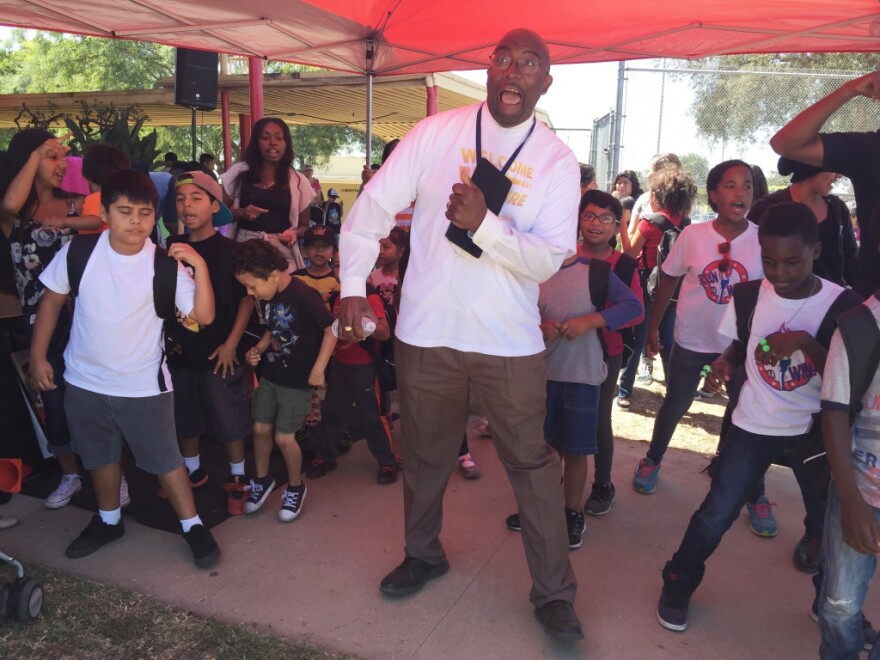State-appointed administrator Vincent Matthews dances the "Cupid Shuffle" with students at a back-to-school event August 19, 2016.