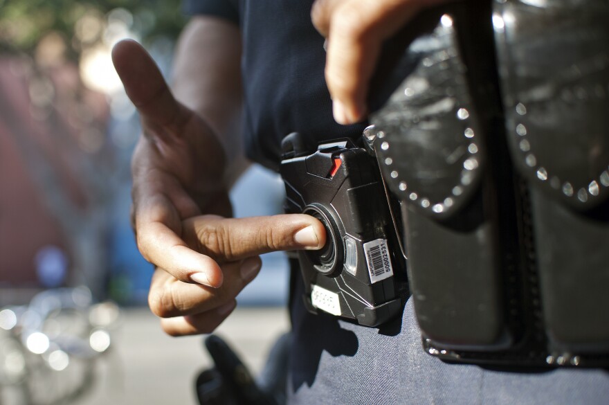 Officer Guillermo Espinoza pushes a button to turn his lapel camera on and off. The cameras don't roll for the entire shift, only when an officer presses record.
