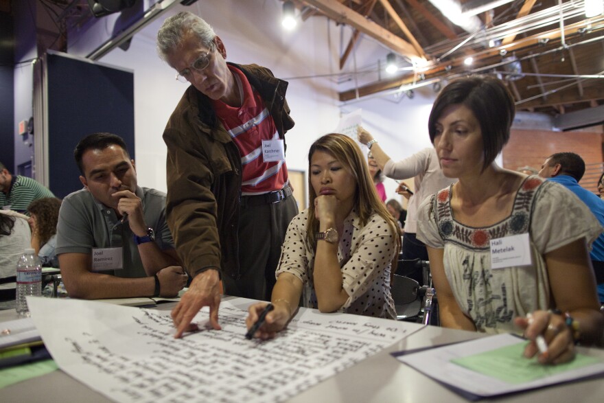 Joel Ramirez, left, Joel Karchmer, Phyllis Castaneda and Hali Metelak discuss questions they posed about the learning environment during a workshop at Wildwood School. The workshop was based around the premise of the book Make Just One Change, which explores the idea of students posing their own questions about a subject instead of teachers formulating a question that all students should think about.