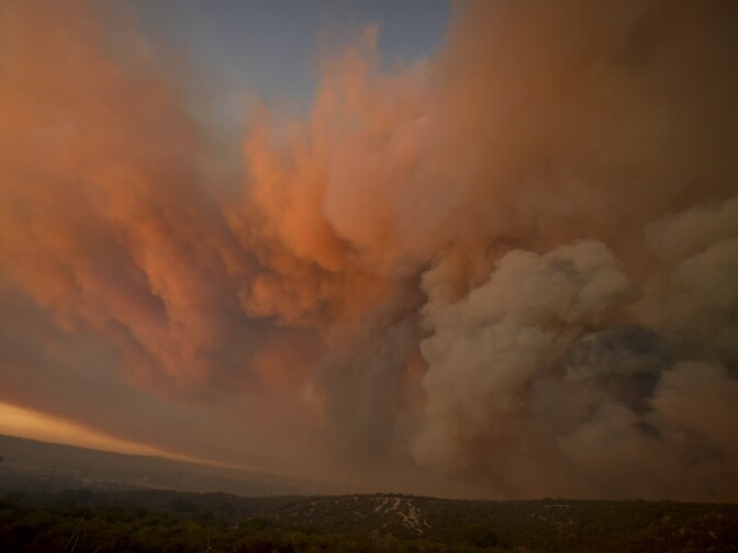 The pyrocumulus created by the Pilot Fire glows pink at sunset Sunday evening. 

The Pilot Fire burns in the San Bernardino National Forest Sunday afternoon August 7th, 2016. The fire had burned over 1,000 acres and was threatening structures. 