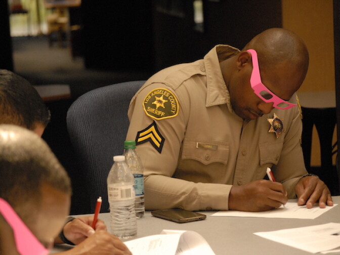 As part of a training exercise on autism, Los Angeles County Sheriff’s Deputy Ralphael Banks donned 3D glasses and wrote with his right hand instead of his dominant left while taking a quiz. The object was to acquaint deputies with the sensory confusion and frustration many autistic people face.