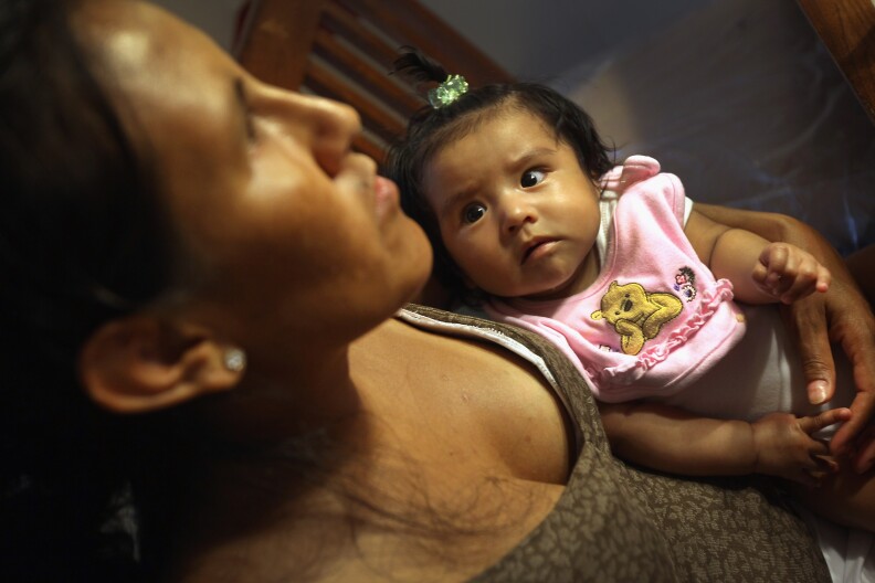 U.S. born Zury Vizguerra, 5 months, gazes at her mother Jeanette Vizguerra, an undocumented Mexican immigrant on July 10, 2011 in Denver, Colorado. Vizguerra has four children, three of whom were born in the U.S. as American citizens. If Vizguerra is deported, her husband and children will stay on in the United States.