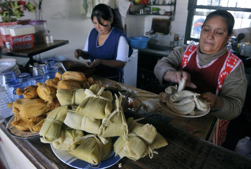 Tamales are displayed in a bar as women prepare empanadas in Salta, at the foothills of the Andes mountain range, in the Argentine northern province of Salta, on June 14, 2009.