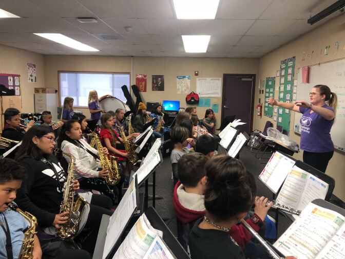 Victoria Batta conducts during an elementary band rehearsal at Three Rings Ranch Elementary School. 